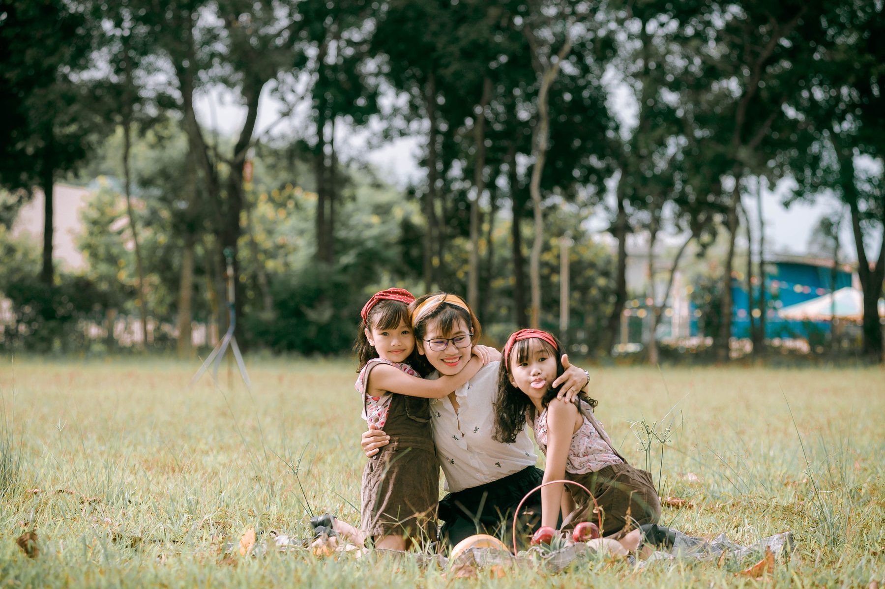 An Asian mother and children sharing a natural moment